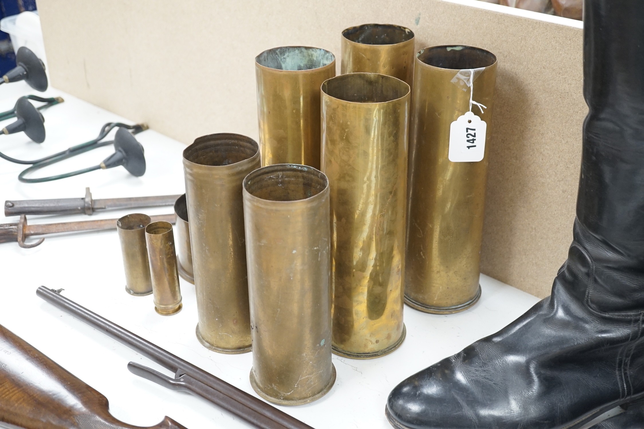 A group of WWI shell casings and two bayonets